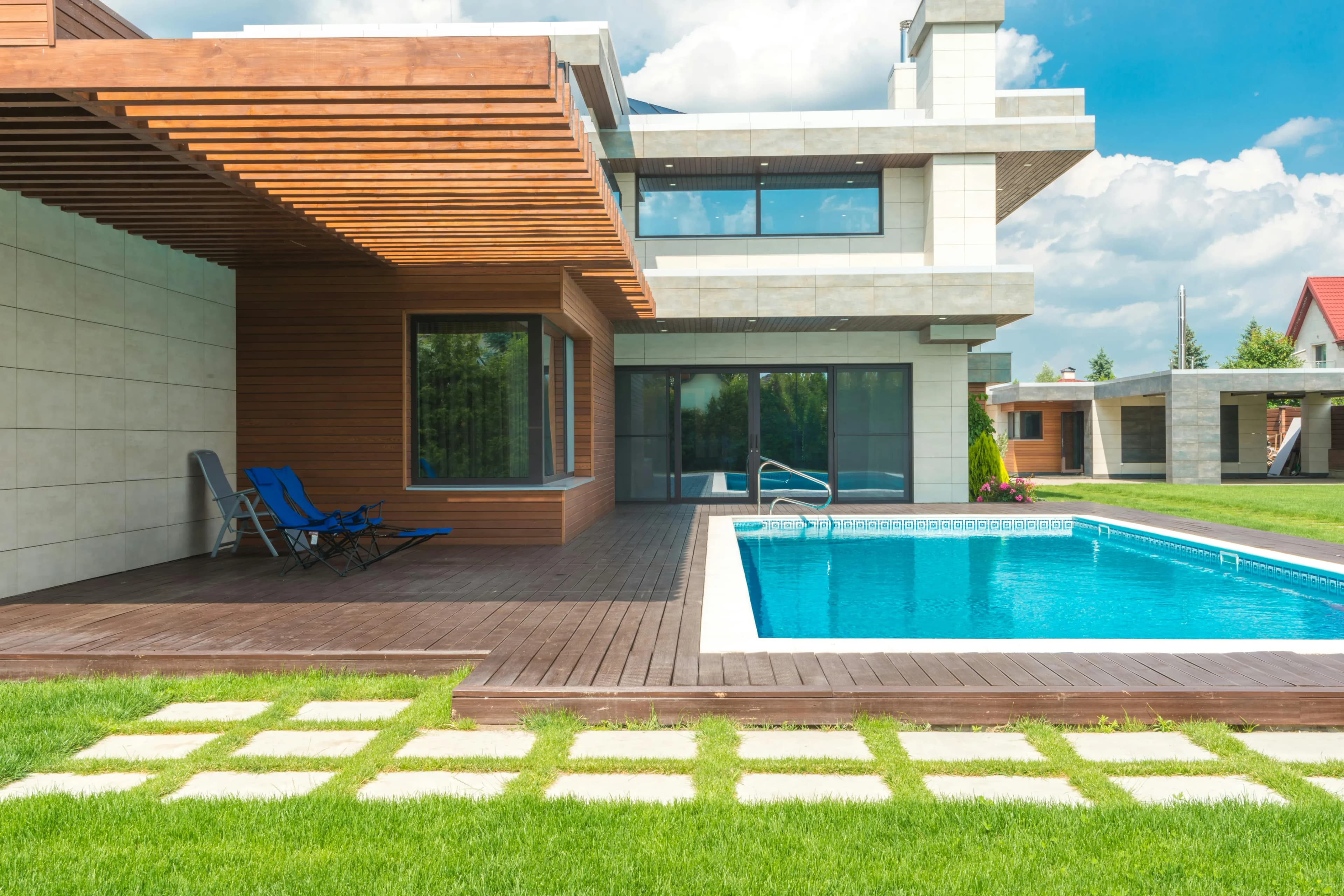 Contemporary home exterior with wood accents, pool deck, and landscaping